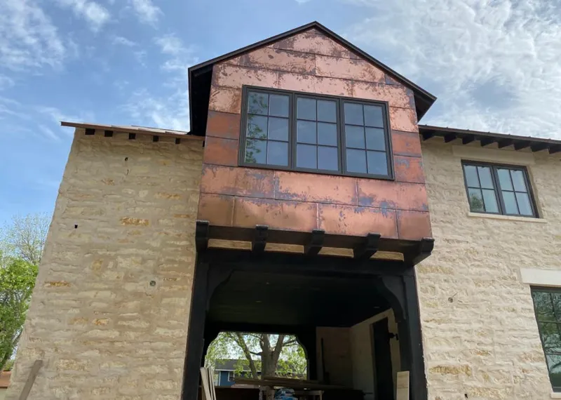 Copper metal panel facade on a stone building for Skylight Installation in Templeton